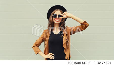 Fashion portrait of beautiful happy young woman, stylish girl smiling in black round hat posing 118373894