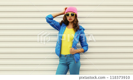 Stylish modern young woman in vivid colorful clothing, pink hat, blue jacket, fashion teenage girl 118373910