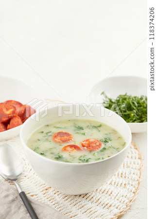 Typical Portuguese soup Caldo Verde with bread and cabbage on white background 118374206
