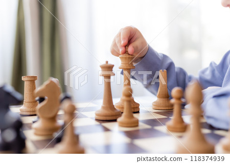 little boy is playing chess at home little boy is playing chess at home 118374939
