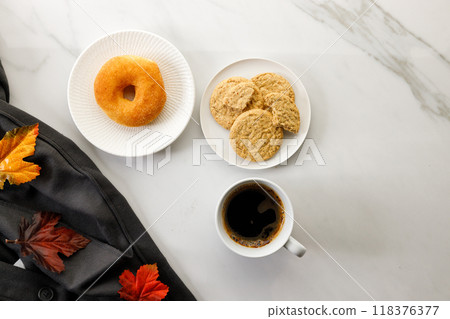Cup of black coffee, Donut, Cookies, leaves, on white marble background. Autumn composition. Copy space. Flat lay. Top view. Cup of black coffee, Donut, Cookies, leaves, on white marble background. Autumn composition. Copy space. Flat lay. Top view. 118376377