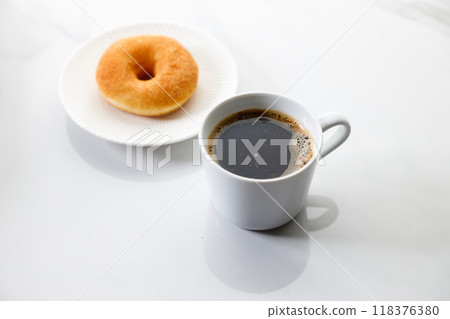 Cup of black coffee, Donut on white marble background. Copy space. Cup of black coffee, Donut on white marble background. Copy space. 118376380