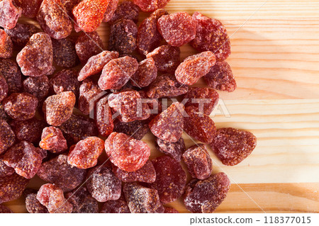Dried red strawberry berries on wooden surface, nobody 118377015