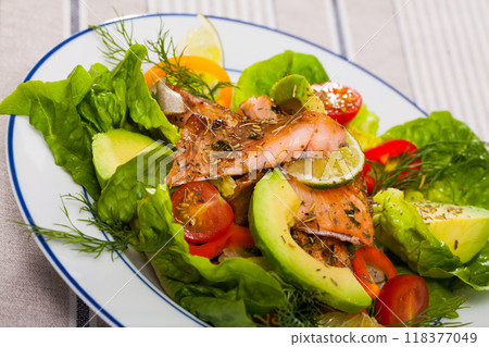 Salad with grilled trout, avocado, tomatoes, lettuce, lemon Salad with grilled trout, avocado, tomatoes, lettuce, lemon 118377049