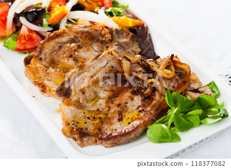 Grilled pork chop with salad of vegetables Grilled pork chop with salad of vegetables 118377082
