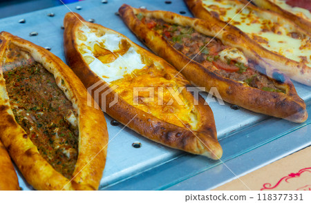 Traditional Turkish pide with various fillings on bakery showcase Traditional Turkish pide with various fillings on bakery showcase 118377331