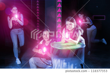 Girls play laser tag, jokingly fight with light weapons 118377353