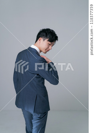 Back view of a man standing in a suit 118377359