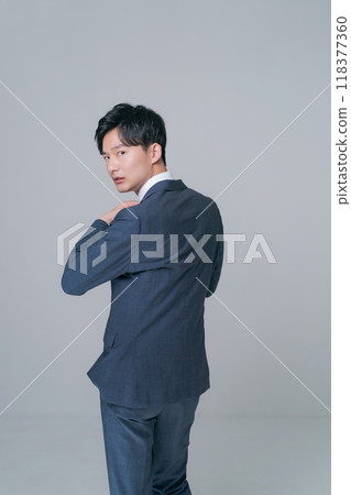 Back view of a man standing in a suit 118377360