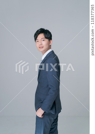 Back view of a man standing in a suit Back view of a man standing in a suit 118377365