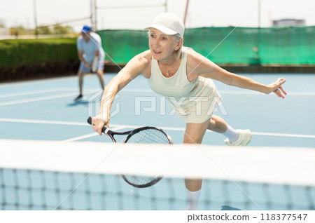 Senior woman plays tennis 118377547
