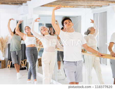 Group of different people doing ballet at barre Group of different people doing ballet at barre 118377620