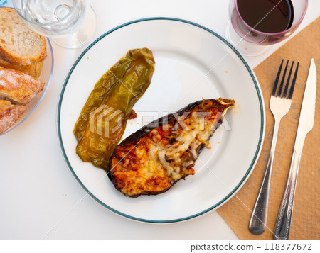 Plate of a dish of baked stuffed eggplant with cheese 118377672
