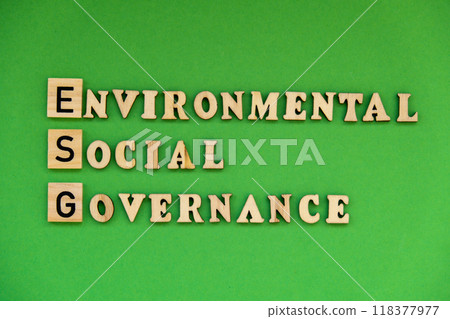 ESG inscription ENVIRONMENTAL SOCIAL GOVERNANCE investment business concept. Text on wooden block on green background. Society and corporate ESG inscription ENVIRONMENTAL SOCIAL GOVERNANCE investment business concept. Text on wooden block on green background. Society and corporate 118377977