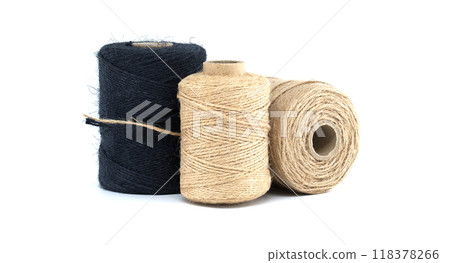 Assorted jute and twine spools on white background showcasing natural fiber materials 118378266
