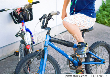 A boy playing with his friends on a bicycle during summer vacation 118378393