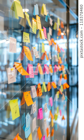A wall covered in colorful sticky notes with various words 118378460