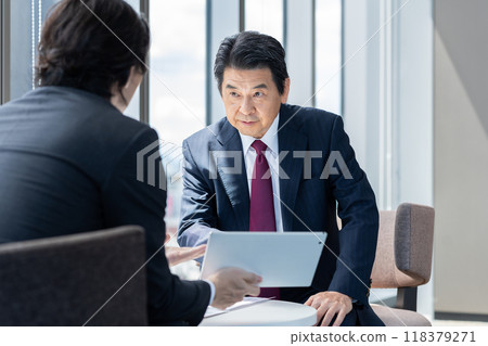 Businessmen having a meeting. Photo courtesy of Denpa Gakuen, Tokyo Electronics College. 118379271