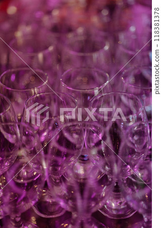 A bunch of glasses are lined up on a table A bunch of glasses are lined up on a table 118381378
