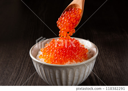 Spoon salmon roe onto rice. 118382291