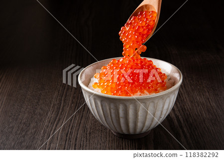 Spoon salmon roe onto rice. 118382292