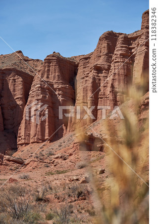 Sheer cliffs, erosion subject, red rocks of Konorchek canyon, travel destination 118382346