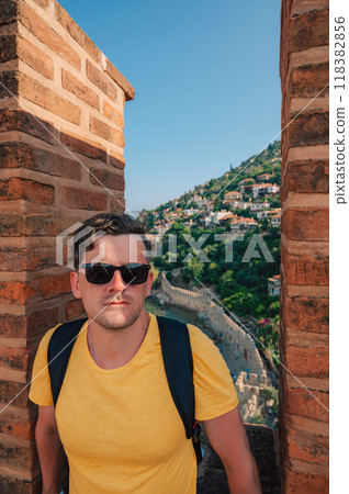 Man at fortress ruins of the historical Red Tower Man at fortress ruins of the historical Red Tower 118382856