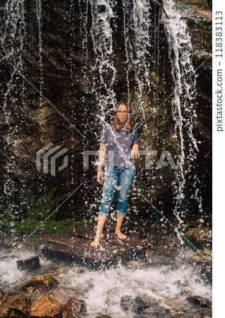 Woman at waterfall in summer Altai Woman at waterfall in summer Altai 118383113
