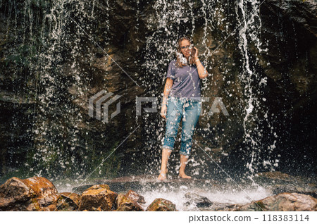 Woman at waterfall in summer Altai Woman at waterfall in summer Altai 118383114
