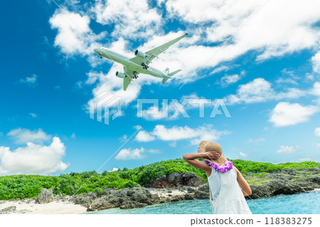 Portrait of a woman looking up at a passenger plane landing at an airport Portrait of a woman looking up at a passenger plane landing at an airport 118383275