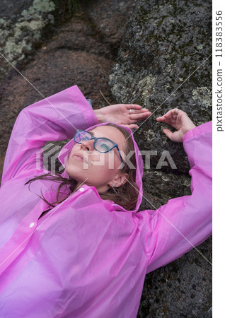 Woman in the taiga forest and rocks of the Stolby nature reserve park 118383556