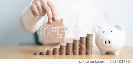 Money Saving, Property investment, House Mortgage, Loan and Real Estate Financial concepts. woman with coins stack piggy bank and Home model, Money stack Counting arrangement for deposit and Tax Money Saving, Property investment, House Mortgage, Loan and Real Estate Financial concepts. woman with coins stack piggy bank and Home model, Money stack Counting arrangement for deposit and Tax 118383780