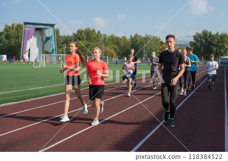 Group of young athletes training at the stadium Group of young athletes training at the stadium 118384522
