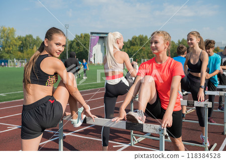 Group of young athletes training at the stadium Group of young athletes training at the stadium 118384528