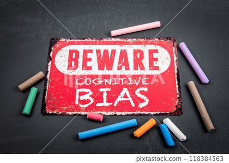Cognitive Bias. Beware sign with text and colored pieces of chalk on a dark chalkboard background Cognitive Bias. Beware sign with text and colored pieces of chalk on a dark chalkboard background 118384563
