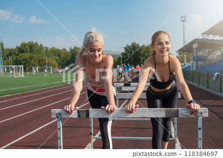Two athlete young woman runner at the stadium 118384697