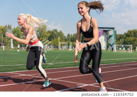 Two athlete young woman runnner at the stadium 118384702