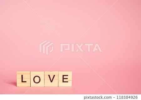 The word love made up of individual letters on a pink background with copy space. Valentine's Day concept The word love made up of individual letters on a pink background with copy space. Valentine's Day concept 118384926