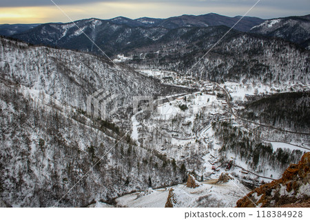 Nature froze in anticipation of spring. Winter Natural landscape at dusk. Village between hillsides. Nature froze in anticipation of spring. Winter Natural landscape at dusk. Village between hillsides. 118384928
