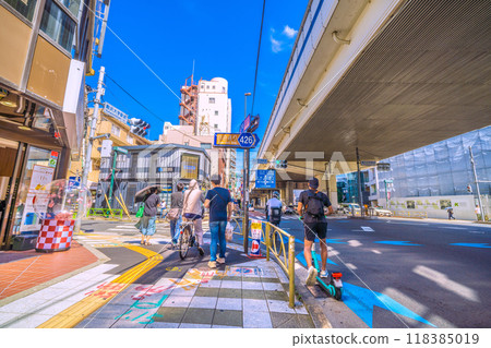 Tokyo cityscape in Japan. The intersection in front of Komazawa Daigaku Station. The west exit of Komazawa Daigaku Station is in the back left of the screen, and the east exit is in the back right. On the right is the redevelopment project in front of the station. Tokyo cityscape in Japan. The intersection in front of Komazawa Daigaku Station. The west exit of Komazawa Daigaku Station is in the back left of the screen, and the east exit is in the back right. On the right is the redevelopment project in front of the station. 118385019