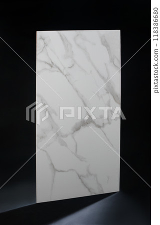 Tiles made of white porcelain stoneware with gray streaks.Black background. Floor or wall tiles. Smooth surface. Granite tiles. 118386680