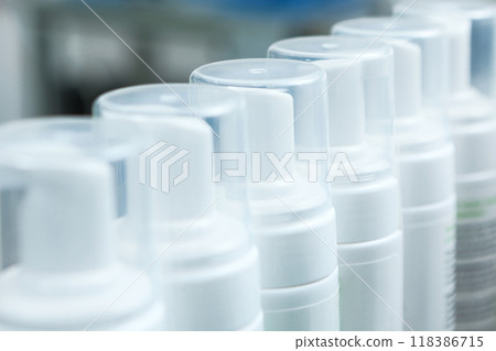 Bottles without labels at the cosmetics factory. Production of cosmetics and skin care products. A white plastic bottle. 118386715
