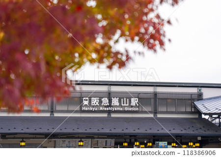 Bright red maple leaves and Hankyu Arashiyama Station 118386906