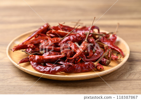 Dried red chili on wooden plate, Food ingredient 118387867