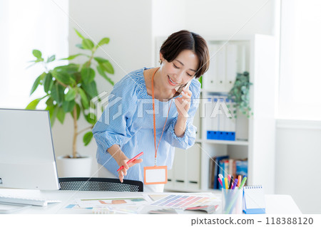 Businesswoman calling at work 118388120