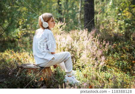 A teenage girl who breathes fresh air and relieves stress in the forest. A teenage girl who breathes fresh air and relieves stress in the forest. 118388128