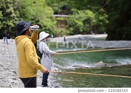Elderly couple fishing and drinking beer on a sunny day 118388143