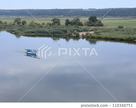 Lonely small boat in the river, shot in the air from hill in Lithuania, quit day 118388751