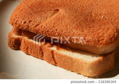 Toast bread on a white plate in the morning sun light. 118390164