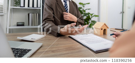 Real Estate Agent Explaining Property Management Contract Details for Client Understanding and Agreement Real Estate Agent Explaining Property Management Contract Details for Client Understanding and Agreement 118390256